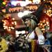 A member of the Krewe of Augstina smiles as she tosses beads to the crowd during the Outback Bowl New Year's eve parade in Ybor City, Fla. on Monday night. Melanie Maxwell I AnnArbor.com
